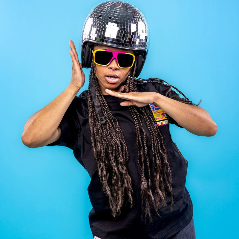 / Polarized Smoke | important_file.JPG | Women in disco ball helmet wears The Italo Flight Optics with a Polarized Smoke lens from Pit Viper Sunglasses