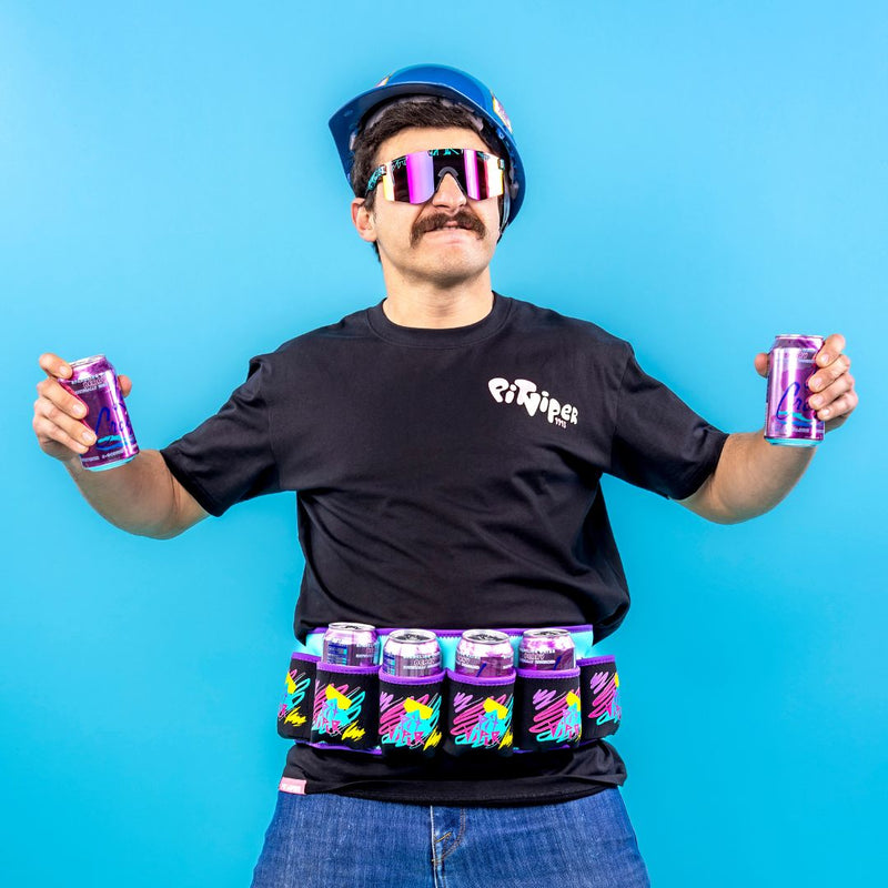 Person wearing hard hat holds two cans while wearing the Waterski Season Beer belt from Pit Viper