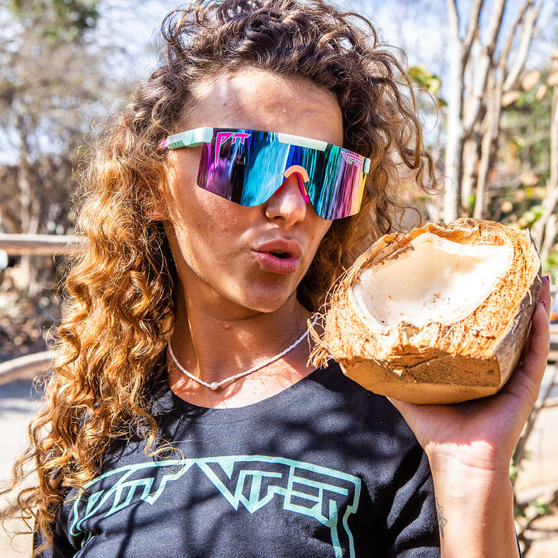 Polarized Blue-Purple | work_on_today.JPG | Woman holding a coconut wearing Pit Viper Sunglasses