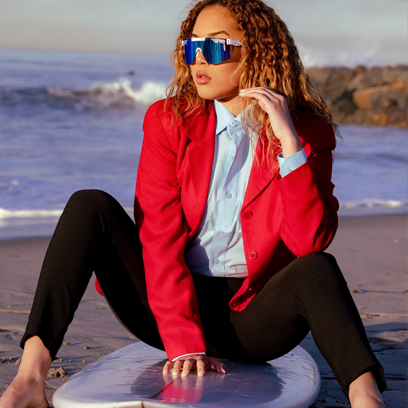 / Polarized Blue | this_one_actually.JPG | Woman posing on surfboard wearing Pit Viper Sunglasses