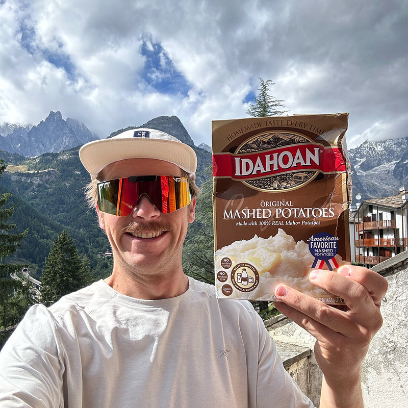 / Rainbow | i_can_stay_late.JPG | A man smiling in the mountains with instant potatoes wearing Pit Viper Sunglasses